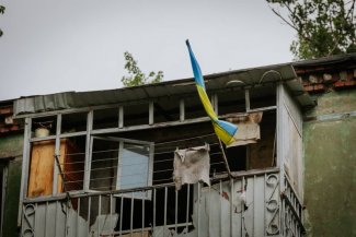 Ukraine flag on destroyed building 