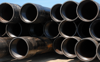 Stack of pipes waiting to be installed at a gas well