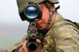 A Turkish soldier poses for a photo as he attends a military exercise